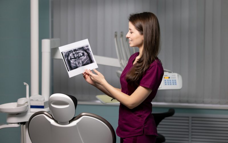 beautiful-woman-doctor-with-dental-scans-in-hands-2023-11-27-05-02-06-utc