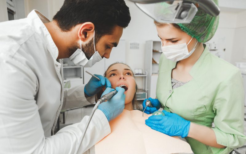 Young talented arabic dentist and his assistant nurse at work